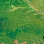 Satellite image of the eastern Pacific Ocean off Central America, with a yellow dashed boundary outlining a volcanic ash advisory area and a small inset legend.