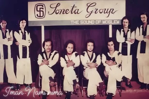 Nine-member band posing on a stage in matching white outfits with black trim; banner above reads 'Soneta Group' and subtitle 'The Sound of ...' as they sit and stand in a row.