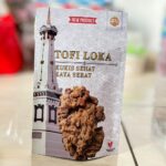 Product packaging for 'TOFI LOKA' healthy-fiber cookies, featuring a tall tower illustration on the left and a cluster of fried cookies in the foreground.