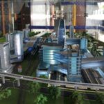 Scale model of a modern city with blue glass buildings, elevated train tracks, and green spaces nearby.