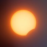 Partial solar eclipse: the Sun with a crescent bite where the Moon covers part of it.