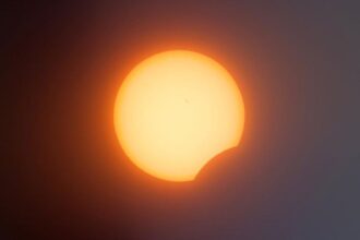 Partial solar eclipse: the Sun with a crescent bite where the Moon covers part of it.