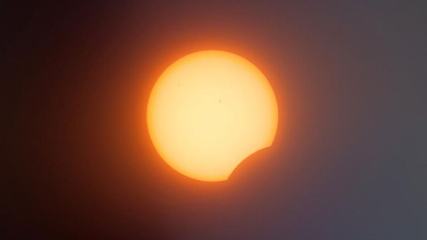 Partial solar eclipse: the Sun with a crescent bite where the Moon covers part of it.