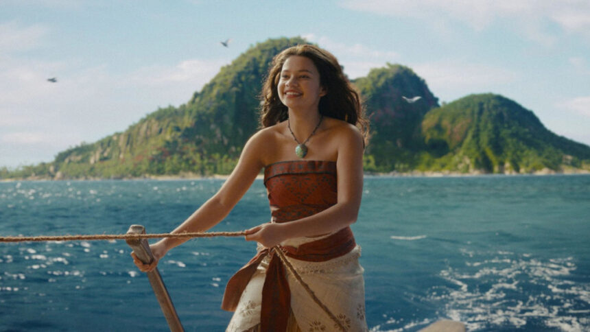 7a8xyz9aZX - Mabur.co Woman on a boat smiling while holding a rope, with blue sea and a green island in the distance behind her.