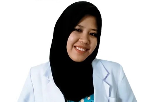 Smiling woman wearing a white lab coat and black hijab, portrait against a white background.