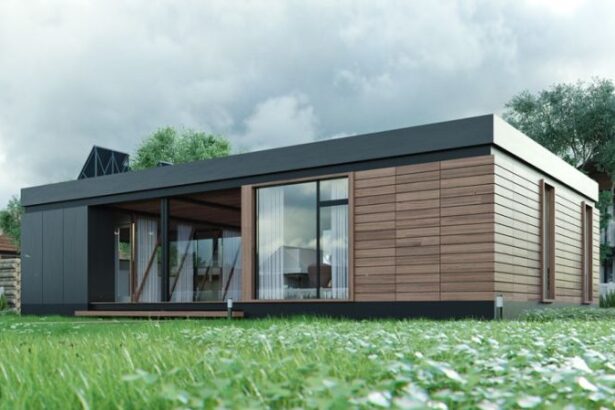 Modern single-story house with wooden cladding and large glass doors, set on a green lawn with a cloudy sky above.
