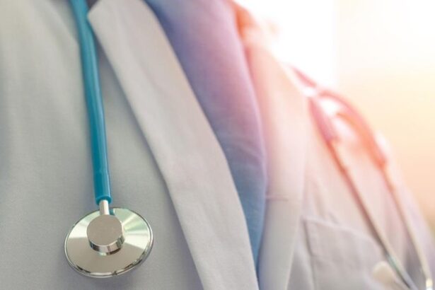 Close-up of a healthcare professional's chest with a blue stethoscope draped around the neck.