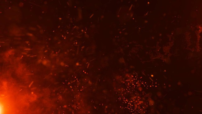 Abstract scene of red-orange sparks and glowing embers against a dark background.