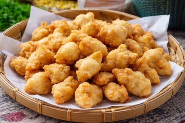 Pile of crispy golden chicken nuggets in a paper-lined wicker basket.