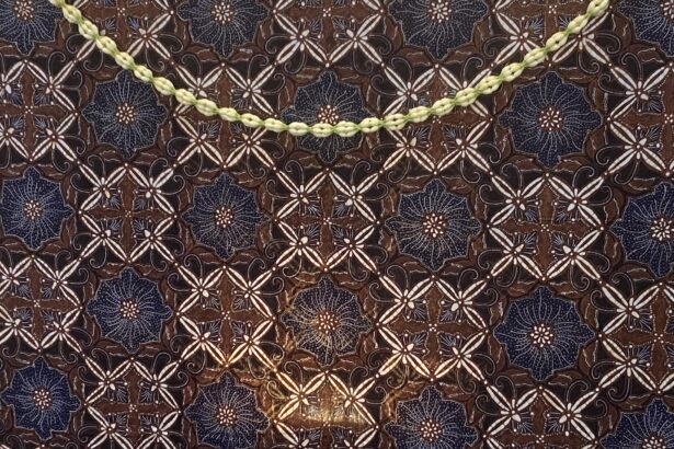 Pale yellow braided cord laid diagonally on a dark blue and brown patterned fabric to show contrast against the textile pattern.