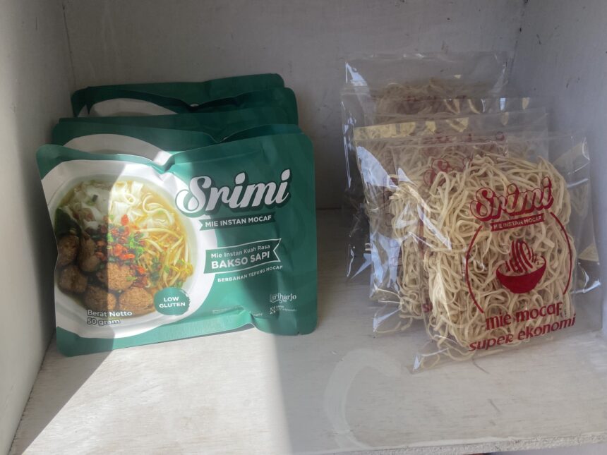 Green Snimi instant noodle package on the left and a clear bag of raw noodles on the right in a freezer.