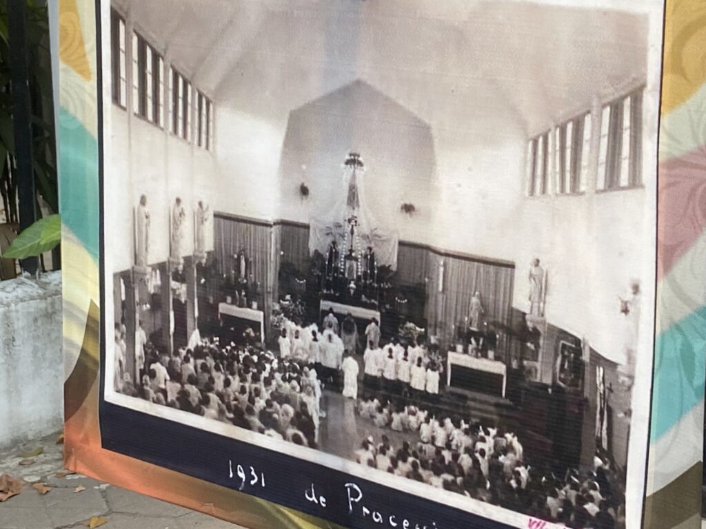 Black-and-white photo of a large church service with clergy at the altar and a crowded congregation, dated 1931.