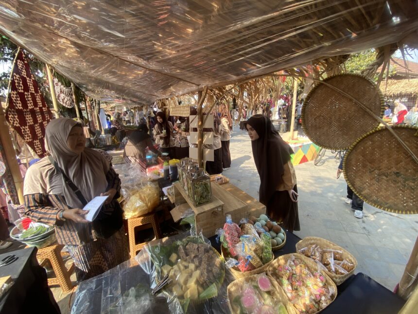 Market stall with women in hijabs selling snacks in clear bags under a plastic-covered roof.