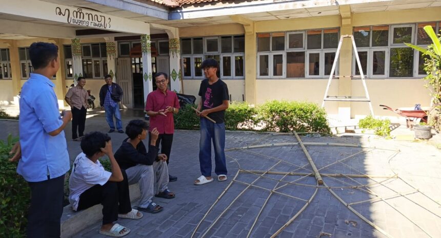 IMG_4576JPG - Mabur.co Group of students outside a school talking, with bamboo poles laid out on the pavement and a ladder in the background.