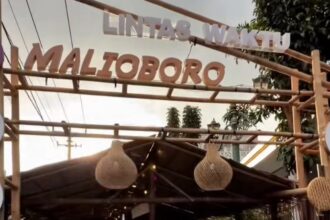 Entrance to a market stall with bamboo frame and hanging woven lanterns.