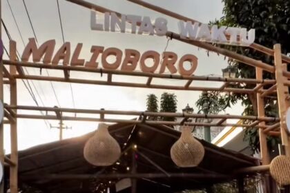 Entrance to a market stall with bamboo frame and hanging woven lanterns.