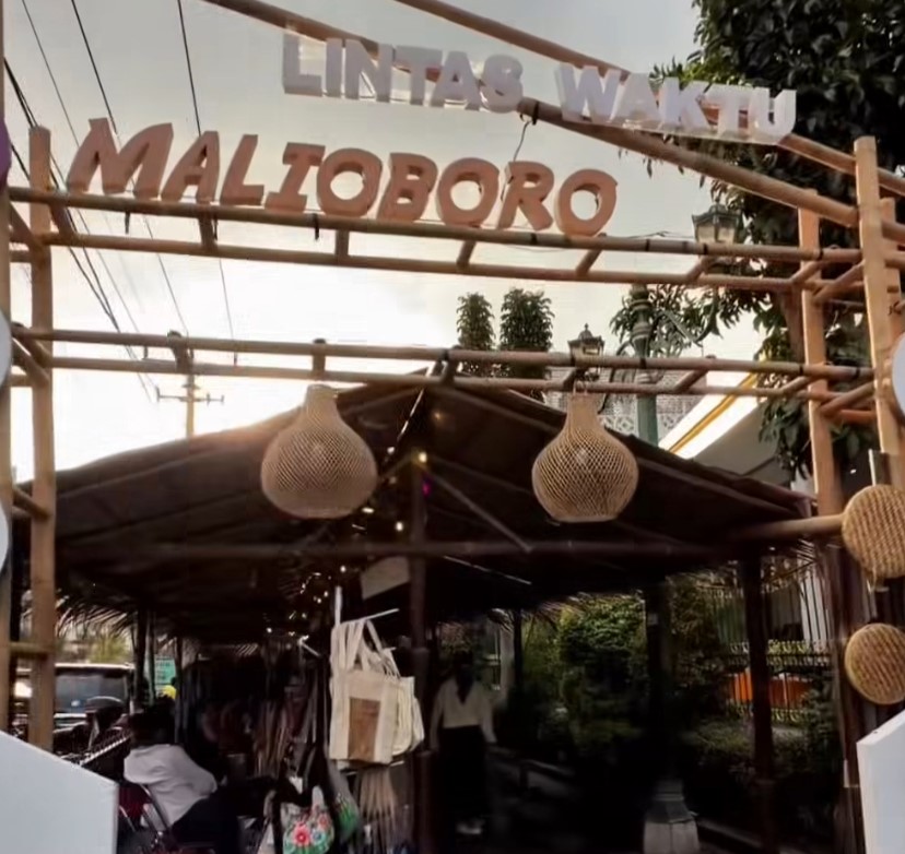 Entrance to a market stall with bamboo frame and hanging woven lanterns.
