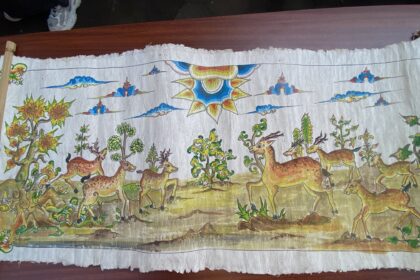 Colorful painted banner showing a forest scene with many deer and a large decorative sun at center-right.