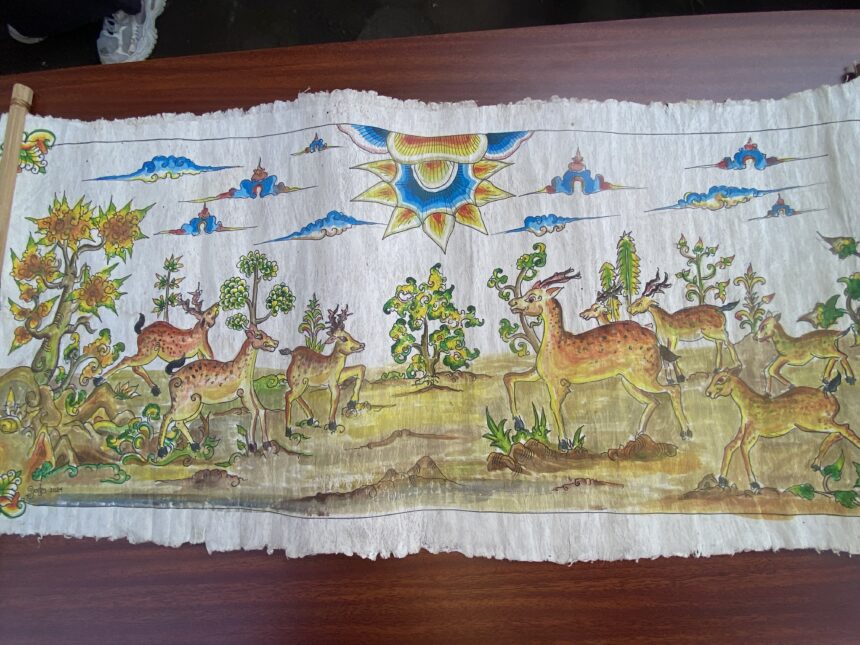 Colorful painted banner showing a forest scene with many deer and a large decorative sun at center-right.