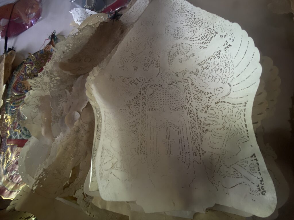 Stacked white lace paper doilies with intricate cutout patterns on a flat surface.