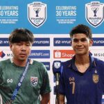 Two football players answer questions at a press conference, backdrop filled with Hyundai and ASEAN logos; one in green jersey with lanyard, the other in blue with number 7 smile behind a microphone.