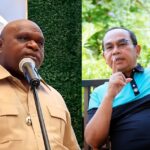 Split image: left, man in tan shirt speaking at a microphone; right, man in blue polo sitting on a bench making a shushing gesture outdoors.