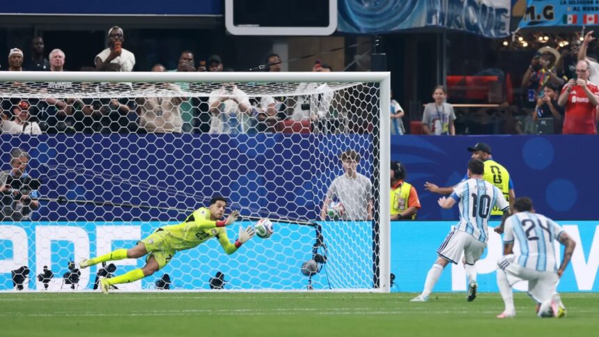 Messi miss penalty vs Egypt by Getty Images - Mabur.co Diving goalkeeper in neon yellow makes a sprawling save near the goal as fans watch from the stands.