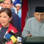 Split-screen: left side shows a woman in a red jacket speaking to reporters with microphones nearby; right side shows a frail man in a white tunic and black cap at a podium.”,