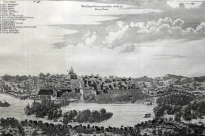 Engraved panorama of a walled fortress town along a river, with towers, church, and surrounding landscape.