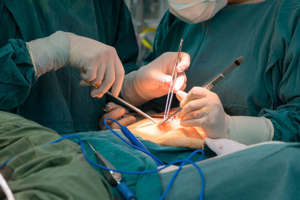 Surgeons in sterile green gowns performing an operation with scalpels and forceps at the patient’s incision site.