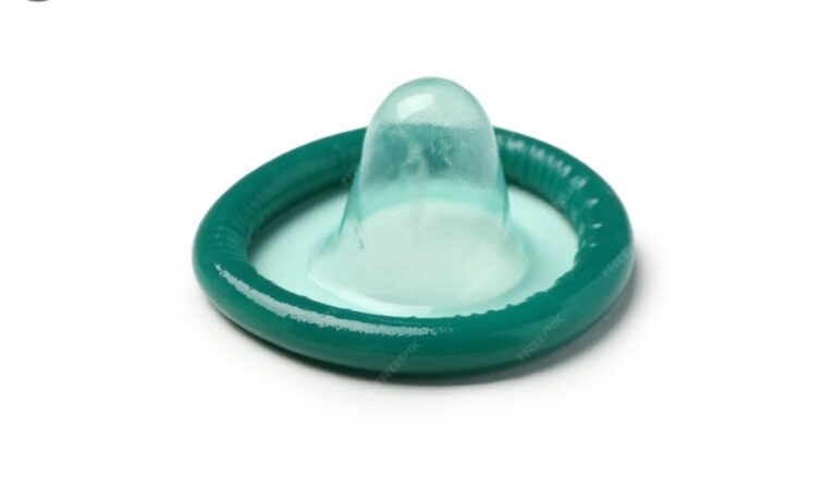 Teal latex condom with a reservoir tip on a white background, ready for use (sexual health condom image)