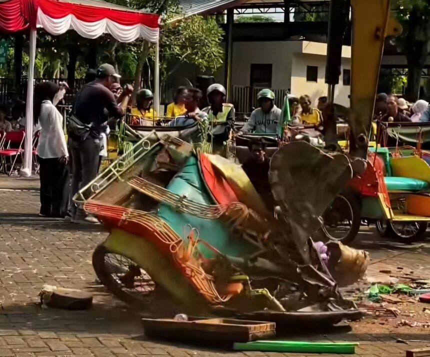 People gathered outdoors under a red-and-white striped canopy, with colorful pedal boats and debris on the ground in a festival-like scene.