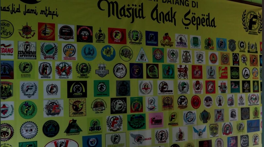 Yellow banner covered with many cycling federation logos in a grid-like collage.