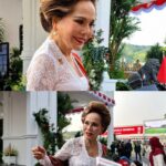 Woman in white lace dress being interviewed by reporters at an outdoor formal event.
