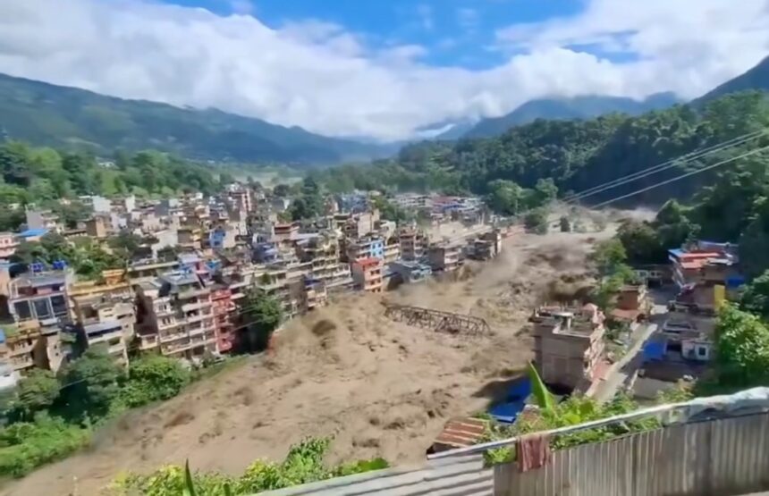 Town on a hillside being hit by a massive landslide sending dust and debris through buildings below