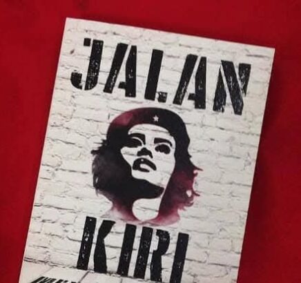 Stencil-style poster featuring a woman's portrait on a white brick background, tilted on a red surface; large text at top says 'JALAN KIRI' with additional text below.