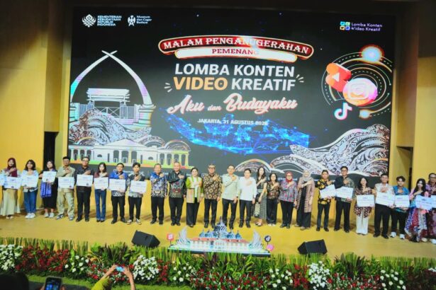 Group photo on stage after a creative video content competition, holding certificates with a large event banner behind them reading ‘Lomba Konten Video Kreatif’ (Jakarta, 2026).