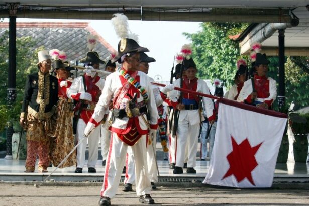 Historical reenactment: soldiers in white uniforms with plumed hats performing on a stage, carrying a white flag with a red star.