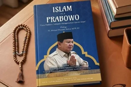 Blue book cover titled 'Islam ALA Prabowo' on a wooden desk, with a photo of a man in a tan uniform and a black cap, plus a wooden prayer bead lei beside it.
