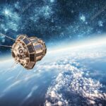 Satellite in space above Earth with a starry background, showing solar panels and antennas.
