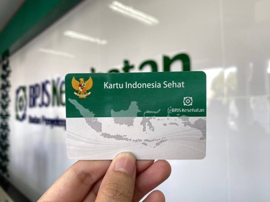 image-25-2 - Mabur.co Indonesian health card Kartu Indonesia Sehat (BPJS Kesehatan) held up in front of a blurred backdrop
