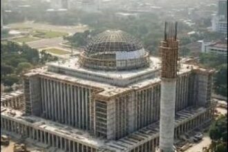 Large government complex under construction with a domed central structure and columned wings.