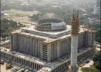 Large government complex under construction with a domed central structure and columned wings.