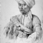 Portrait of a man in a turban and traditional robe, with a ceremonial sword across his chest.