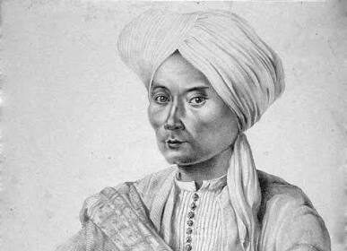 Portrait of a man in a turban and traditional robe, with a ceremonial sword across his chest.