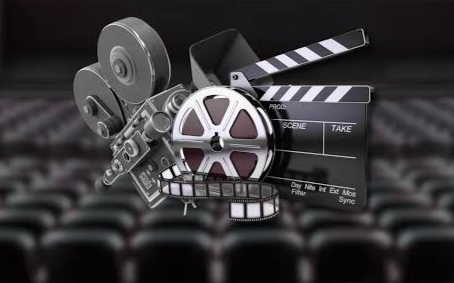 Collage of cinema equipment: film reels, a movie camera, and a clapperboard in a theater setting.