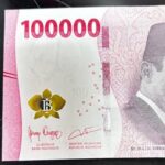 Indonesian 1,000,000-rupiah banknote with pink design, a yellow flower emblem, and a portrait on the right side.