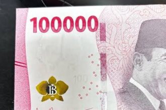 Indonesian 1,000,000-rupiah banknote with pink design, a yellow flower emblem, and a portrait on the right side.