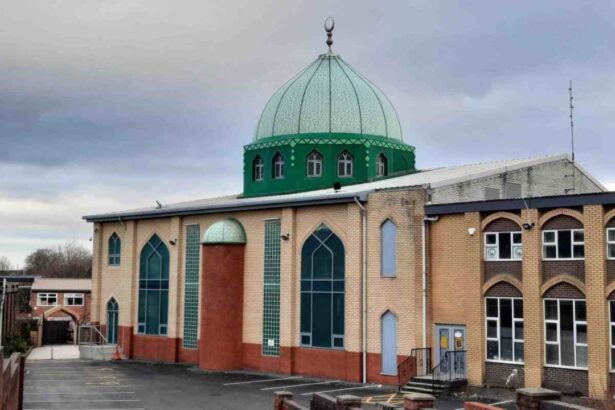 Brick building with a prominent green dome and tall arched windows, suggesting a religious or cultural center.