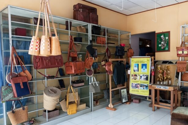 Boutique display of leather handbags and purses on metal shelves in a sunny shop interior